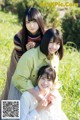 A group of three young women posing for a picture in a field.